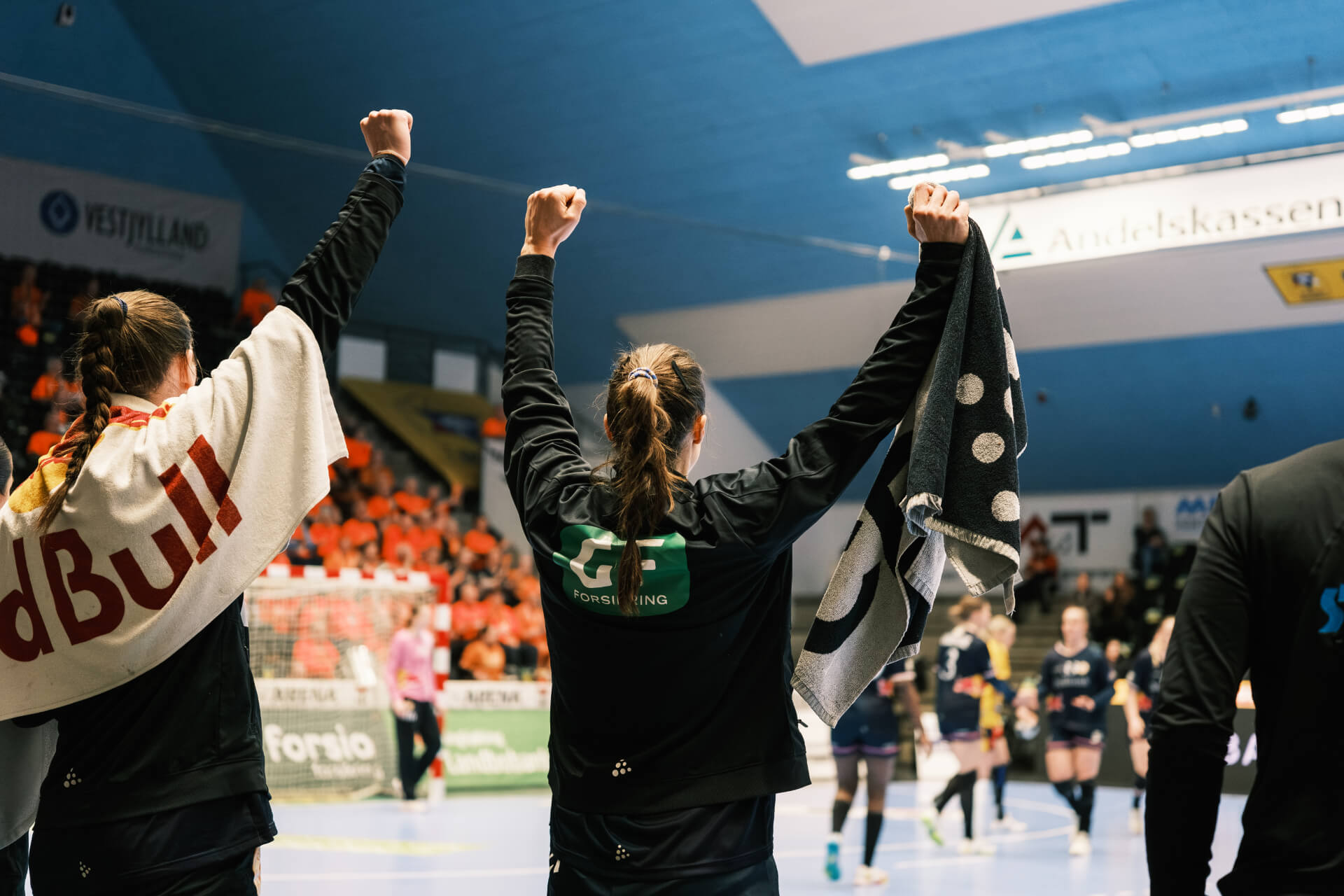 Spillere fra Odense Håndbold fejrer sejr foran fansene